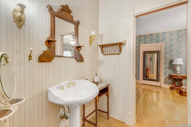 a bathroom with a sink mirror and vanity