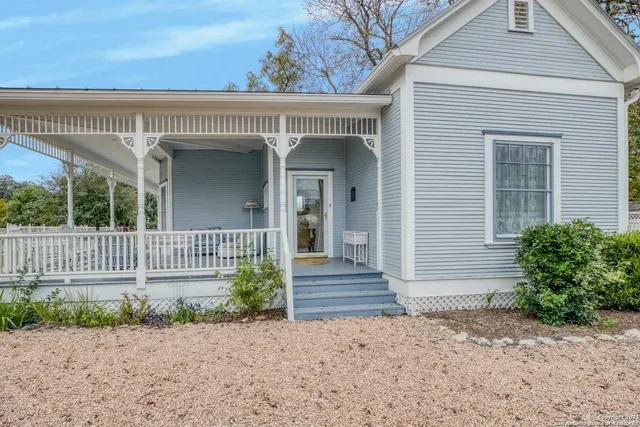a view of a house with a small yard and plants