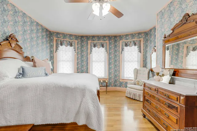 a bedroom with a bed and a large window