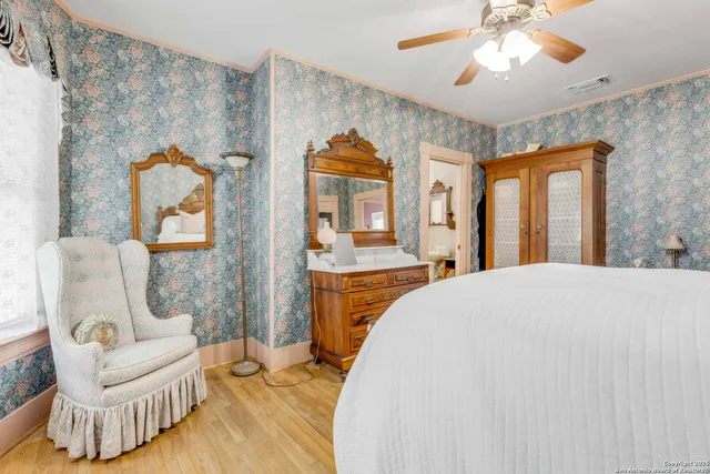 a spacious bedroom with a bed and a chair