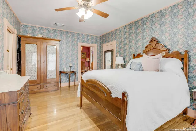 a bedroom with a bed and a chandelier