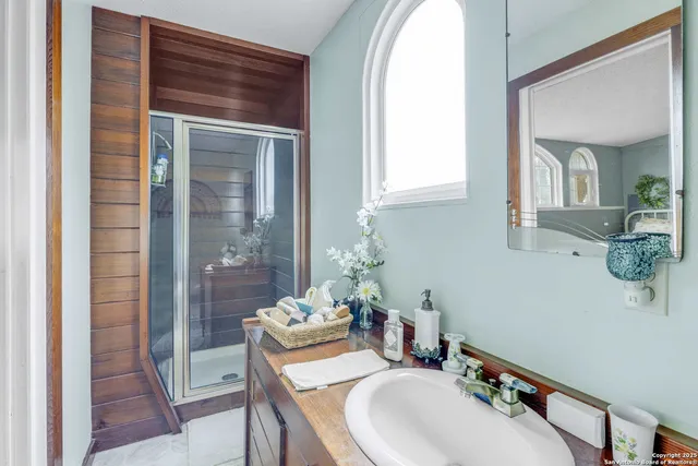 a bathroom with a sink vanity granite and a mirror