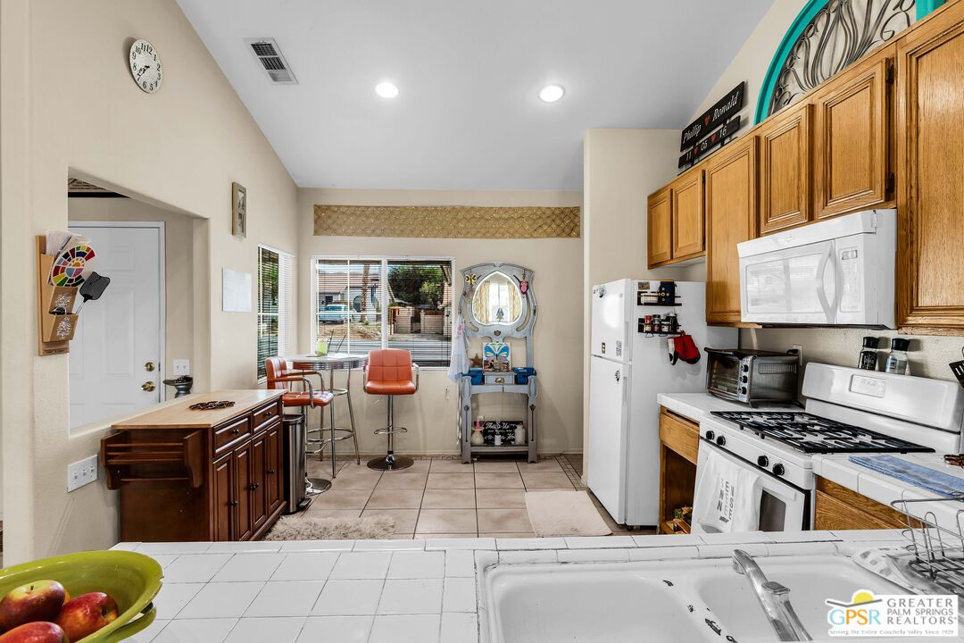 13753 Inaja Street Desert Hot Springs, CA 92240 - Photo 13 of 24 a kitchen with lots of appliances