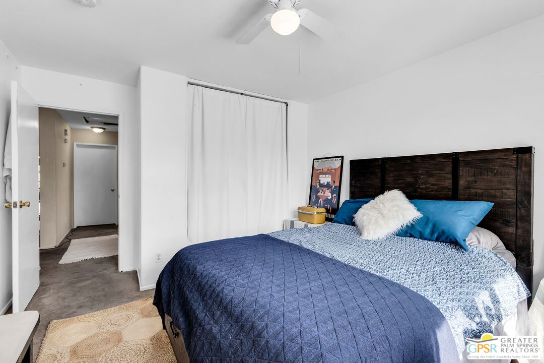 13753 Inaja Street Desert Hot Springs, CA 92240 - Photo 15 of 24 a bedroom with a bed and a potted plant