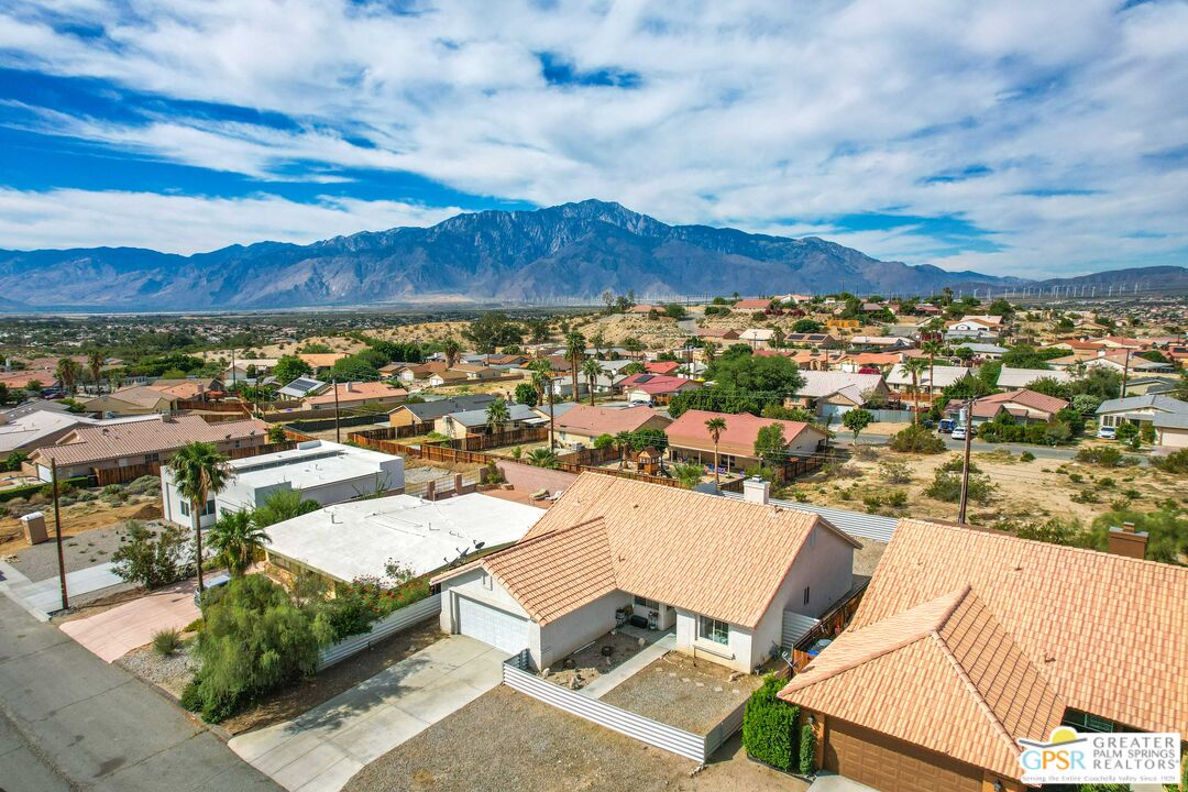 13753 Inaja Street Desert Hot Springs, CA 92240 - Photo 2 of 24 an aerial view of residential houses with outdoor space