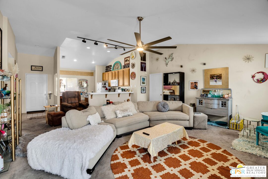 13753 Inaja Street Desert Hot Springs, CA 92240 - Photo 3 of 24 a living room with furniture and a chandelier