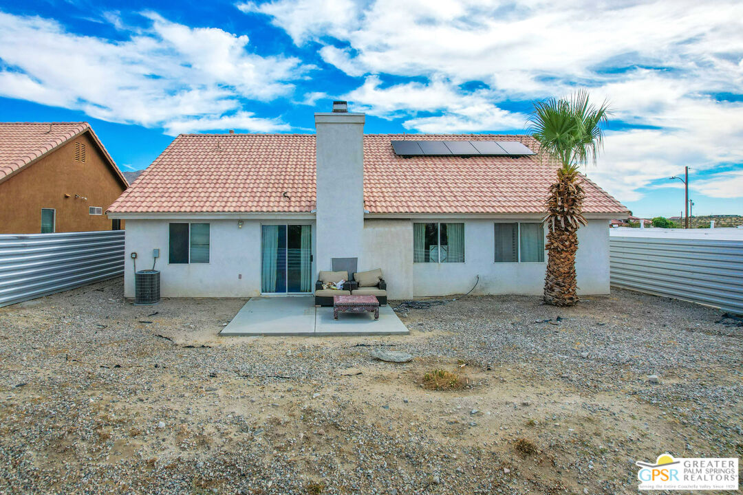 13753 Inaja Street Desert Hot Springs, CA 92240 - Photo 9 of 24 a front view of a house with garden