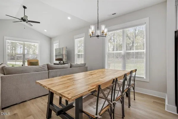 a view of a dining room with furniture window and wooden floor
