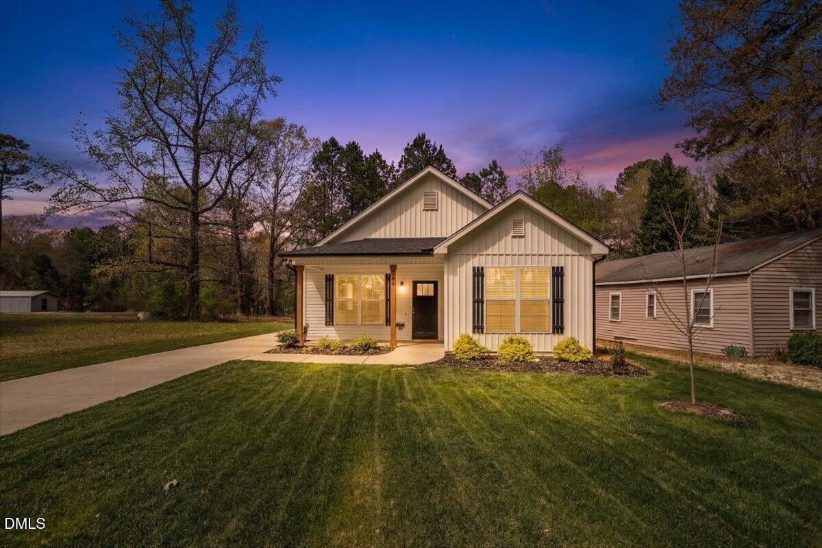 506 Dogwood Road Holly Springs, NC 27540 - Photo 2 of 42 a front view of a house with a yard and trees