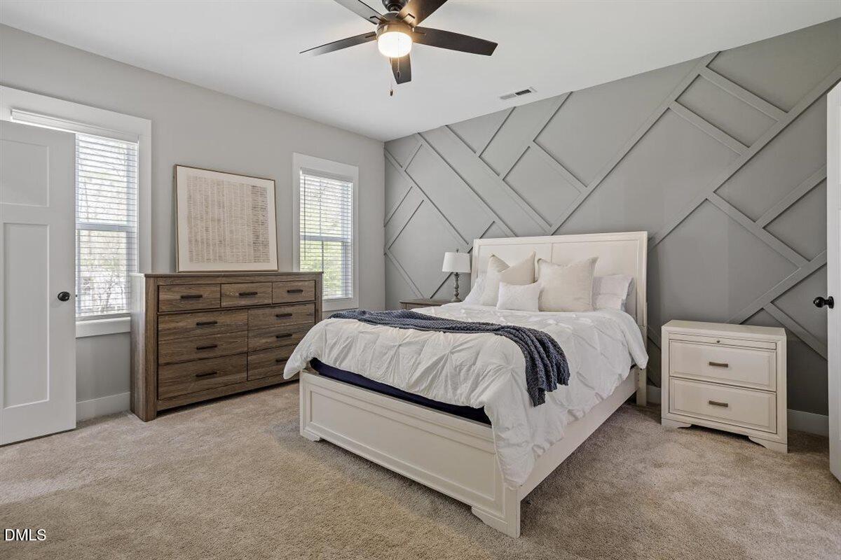 506 Dogwood Road Holly Springs, NC 27540 - Photo 21 of 42 a spacious bedroom with a bed and a couch