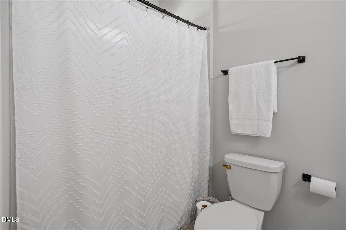 506 Dogwood Road Holly Springs, NC 27540 - Photo 28 of 42 a white toilet sitting next to a shower