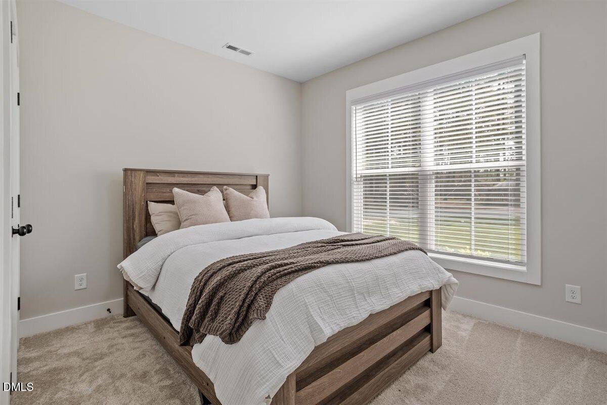 506 Dogwood Road Holly Springs, NC 27540 - Photo 29 of 42 a bedroom with a bed and window