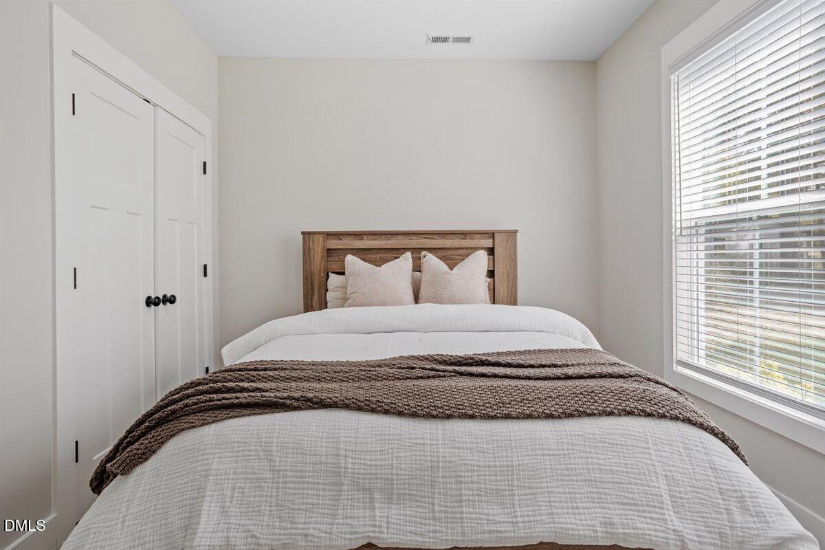 506 Dogwood Road Holly Springs, NC 27540 - Photo 30 of 42 a bedroom with a bed and a window