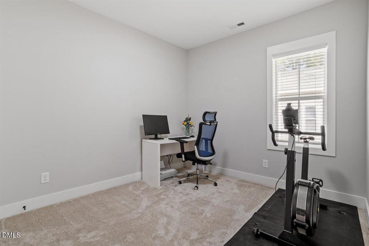 506 Dogwood Road Holly Springs, NC 27540 - Photo 33 of 42 a view of a workspace with furniture and a window