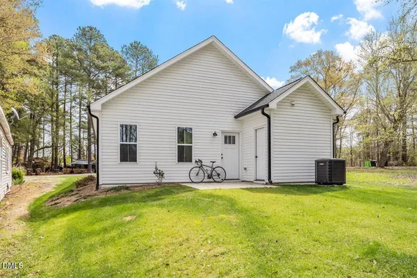 a view of a house with yard and sitting area