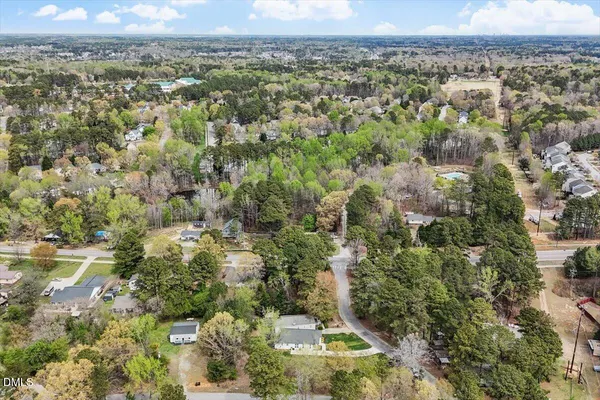 an aerial view of a houses with a yard