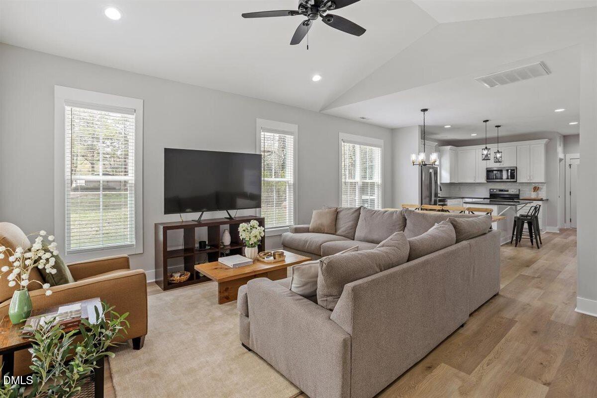506 Dogwood Road Holly Springs, NC 27540 - Photo 4 of 42 a living room with furniture and a flat screen tv