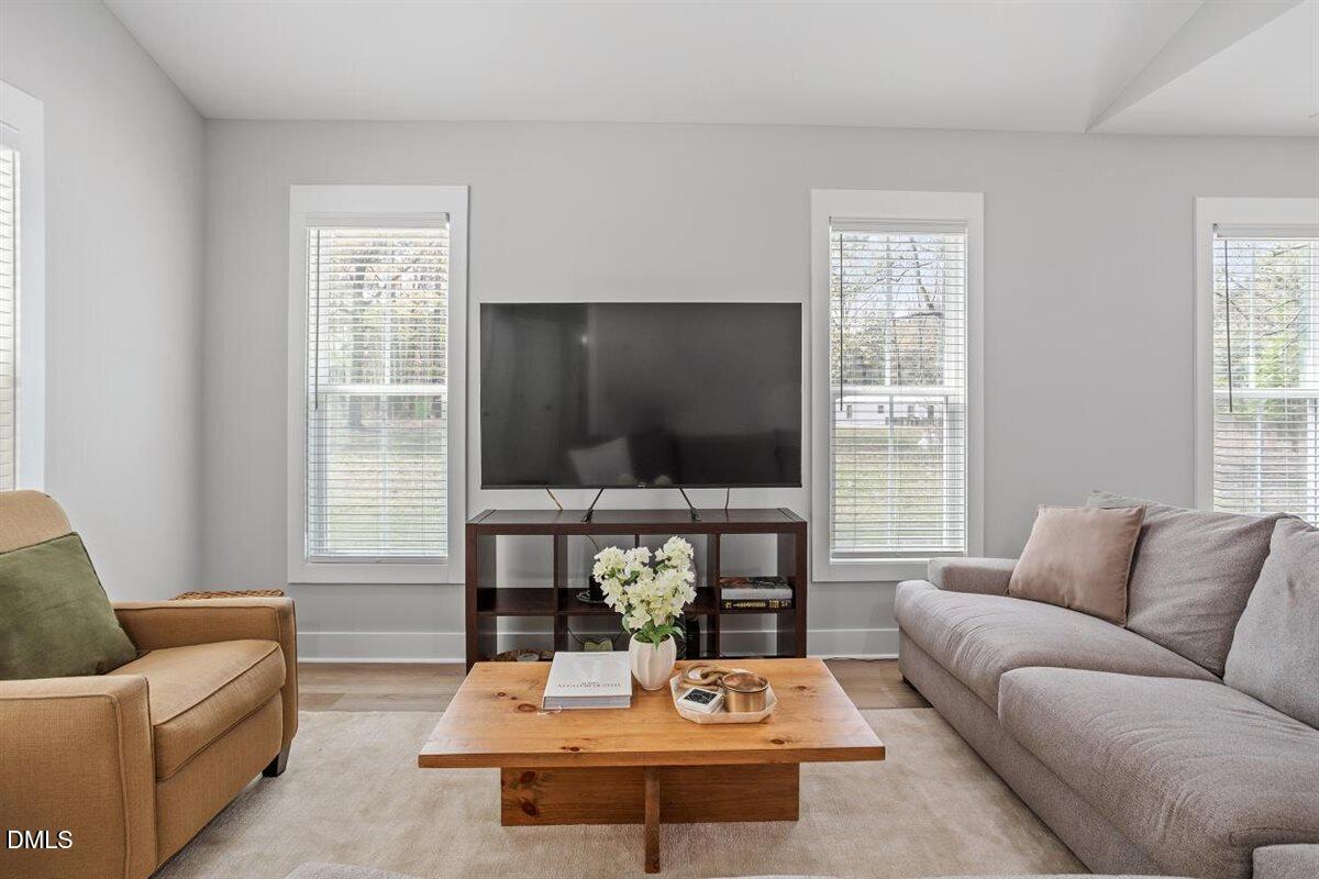 506 Dogwood Road Holly Springs, NC 27540 - Photo 7 of 42 a living room with furniture a flat screen tv and a large window