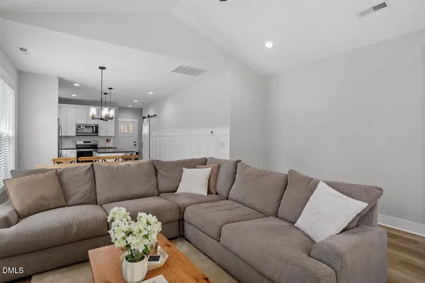 a living room with furniture and kitchen view