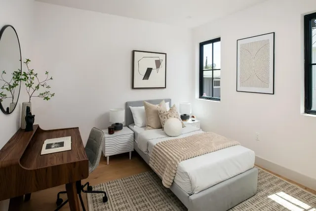 a bedroom with a bed and a window