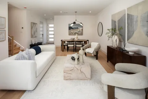 a living room with furniture or couch and a chandelier