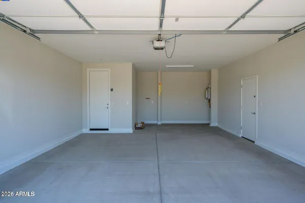 a view of a room with a window and a ceiling fan