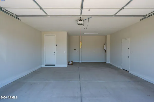 a view of a room with a window and a ceiling fan