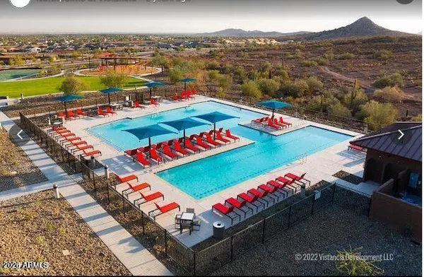 a living room with patio furniture and a large window
