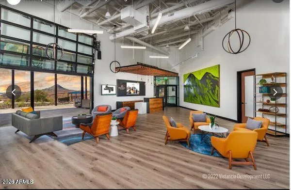 a living room with patio furniture and a large window