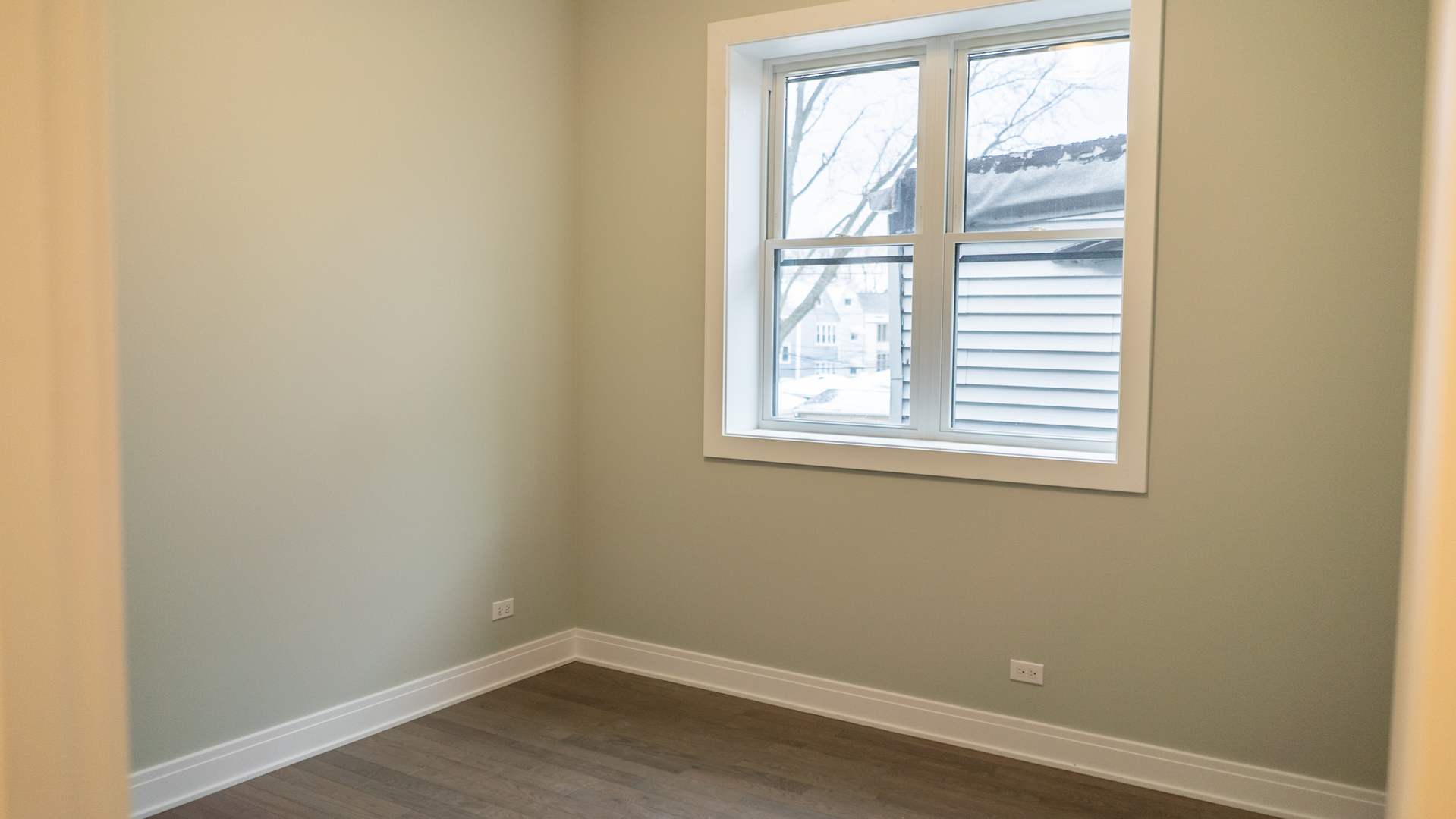 4211 West Roscoe Street, Unit 2W Chicago, IL 60641 - Photo 4 of 12 an empty room with a window