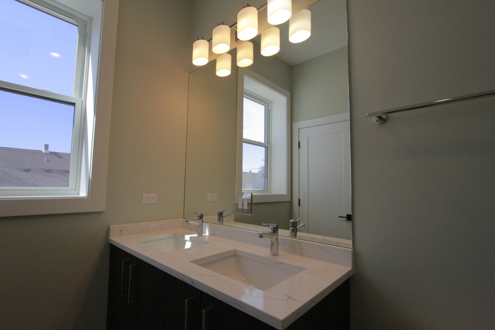 4211 West Roscoe Street, Unit 2W Chicago, IL 60641 - Photo 8 of 12 a bathroom with a sink and a mirror
