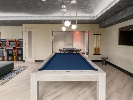 a room with pool table and flat screen tv