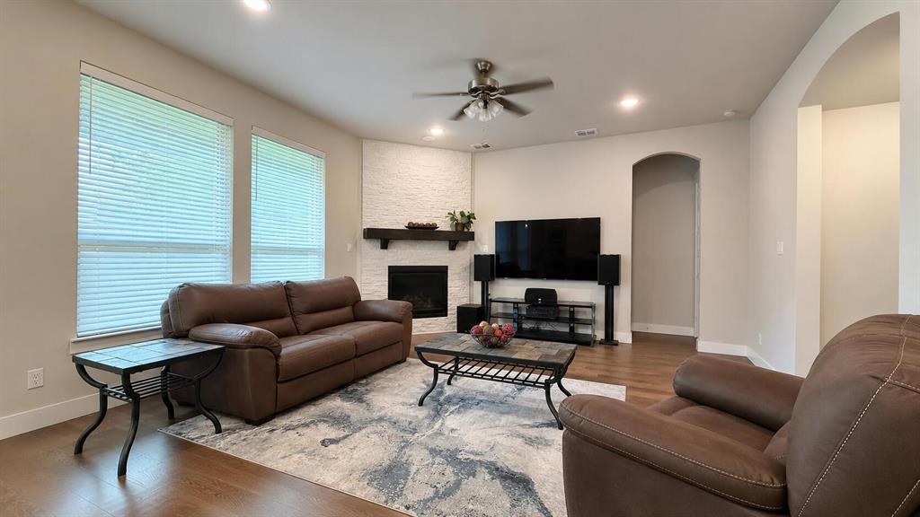 912 Fallbrook Avenue Denton, TX 76210 - Photo 4 of 26 a living room with furniture and a flat screen tv