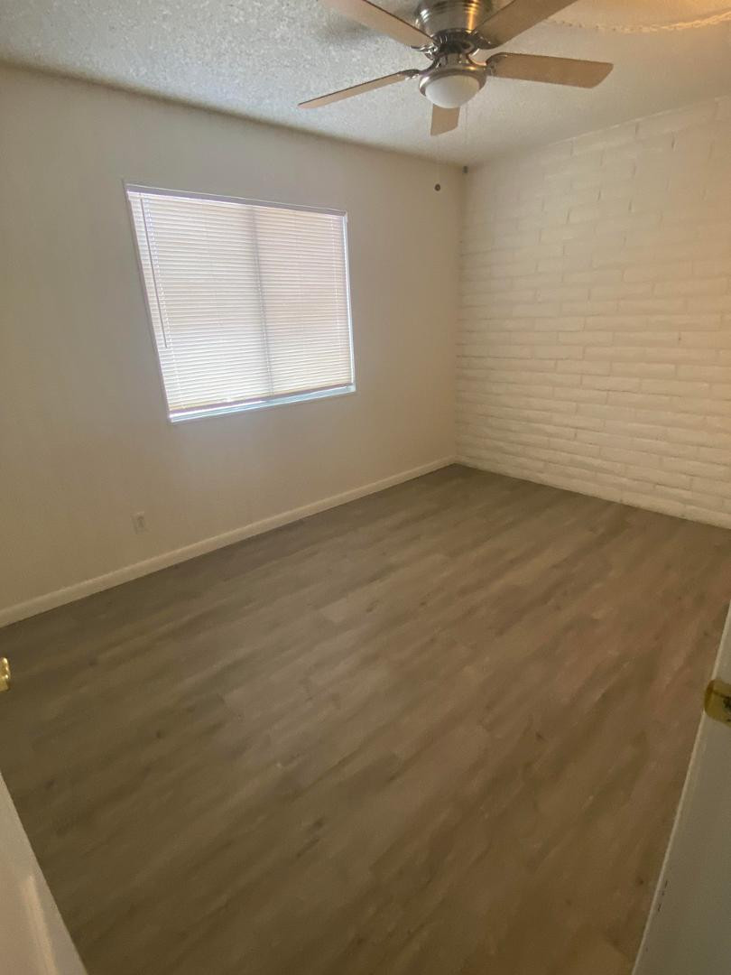 4140 East Cliffside Trail, Unit G Rimrock, AZ 86335 - Photo 5 of 25 an empty room with a window and a fan