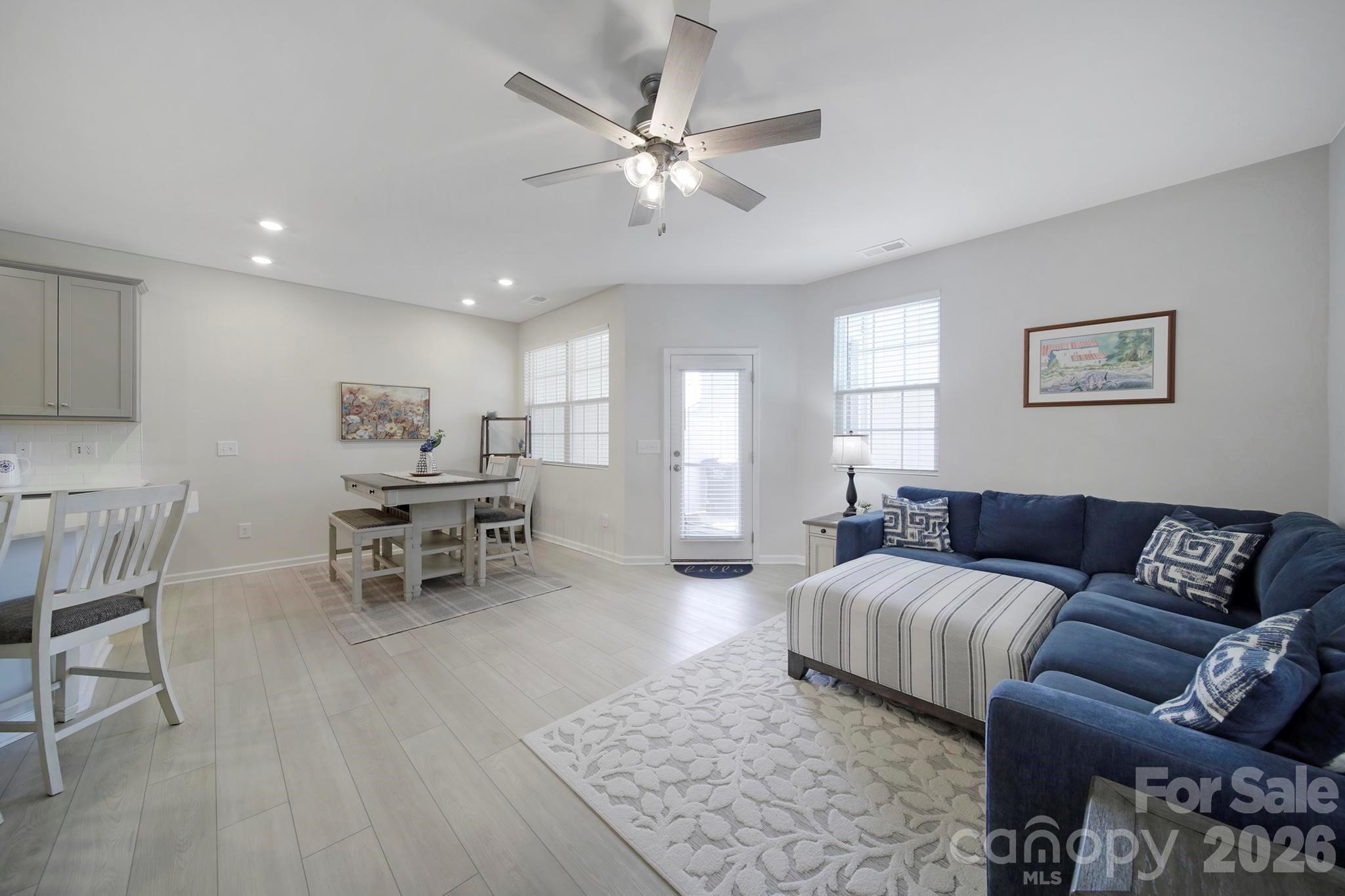 7032 Everly Commons Lane Fort Mill, SC 29708 - Photo 15 of 37 a living room with furniture and a dining table with wooden floor