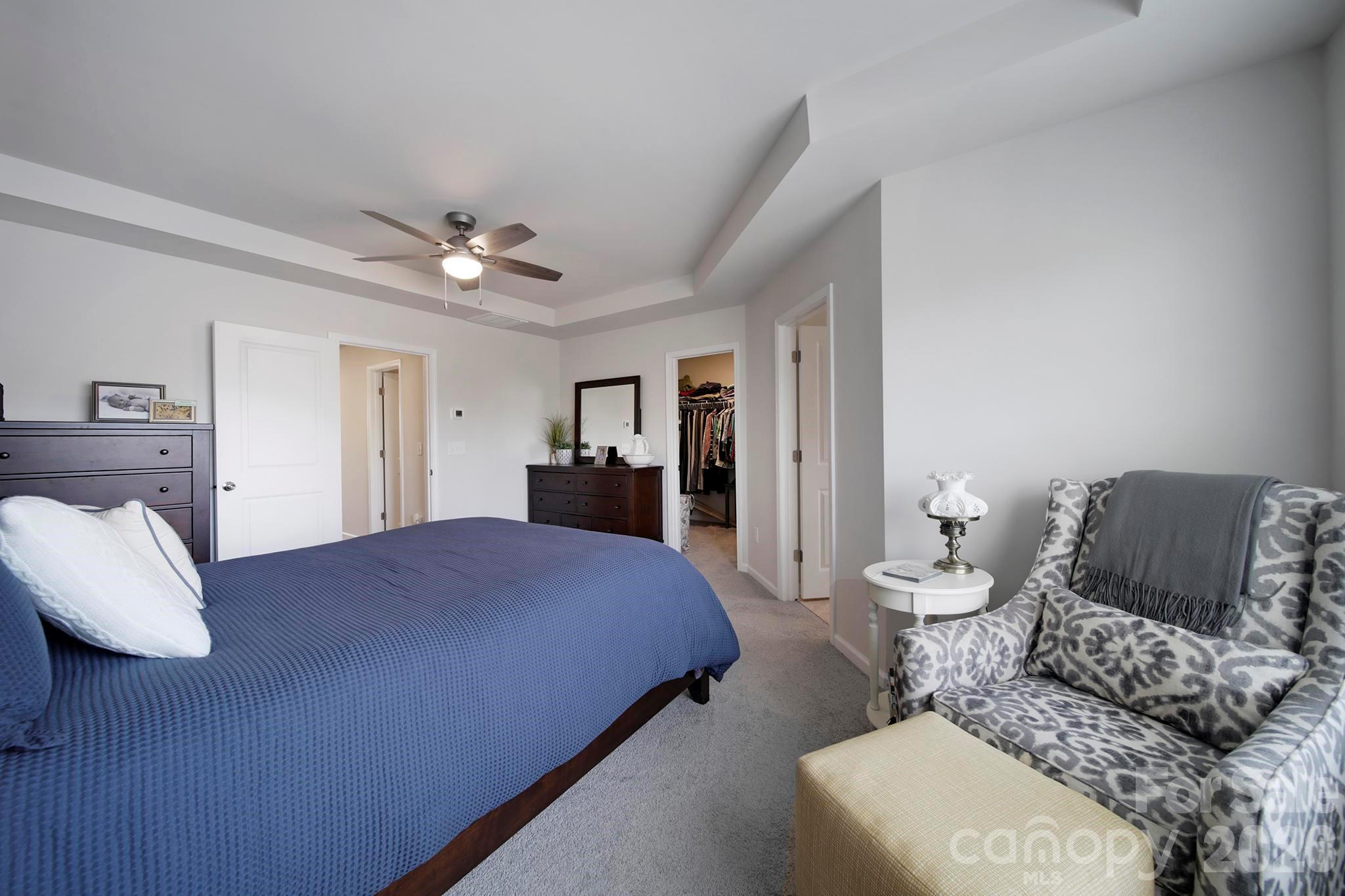 7032 Everly Commons Lane Fort Mill, SC 29708 - Photo 17 of 37 a spacious bedroom with a bed and furniture