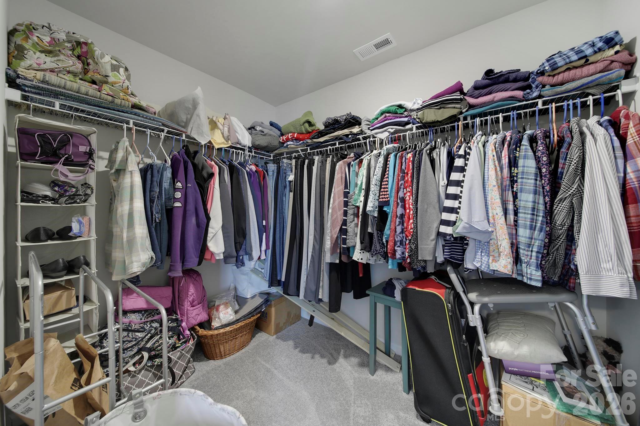 7032 Everly Commons Lane Fort Mill, SC 29708 - Photo 19 of 37 a view of walk in closet with clothes and shoes