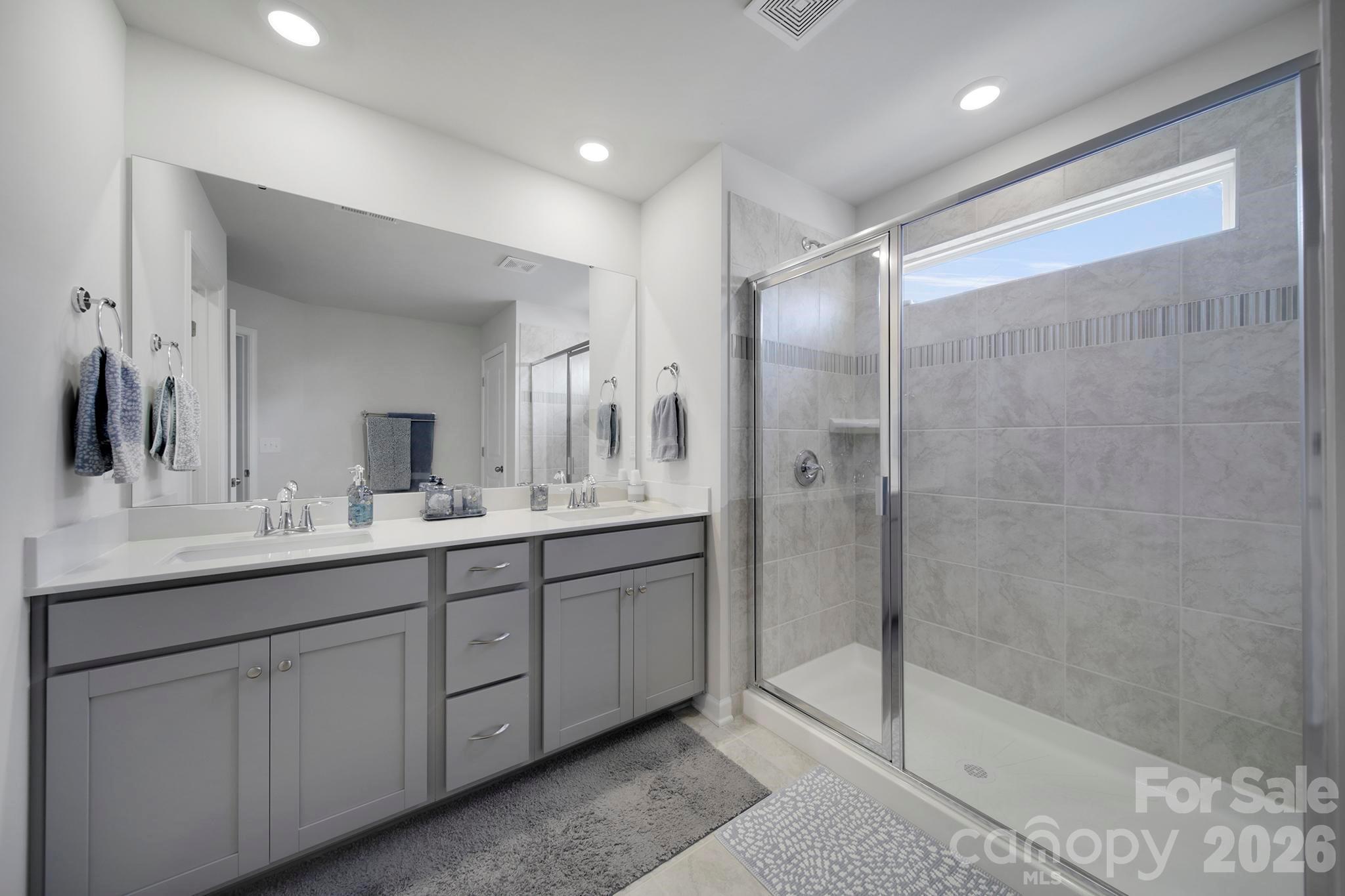 7032 Everly Commons Lane Fort Mill, SC 29708 - Photo 20 of 37 a bathroom with a double vanity sink mirror and shower