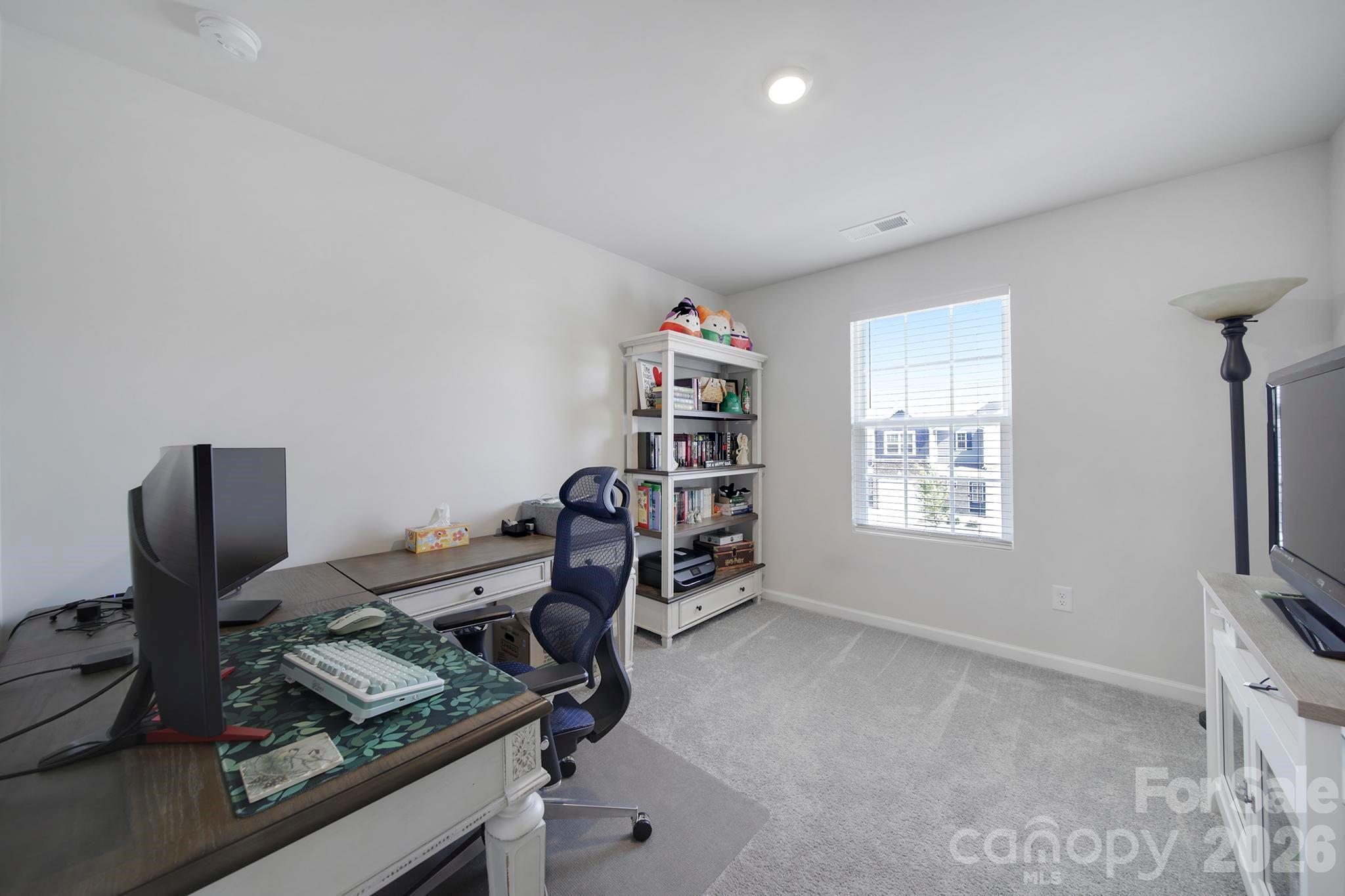 7032 Everly Commons Lane Fort Mill, SC 29708 - Photo 21 of 37 a view of a workspace with furniture and a window