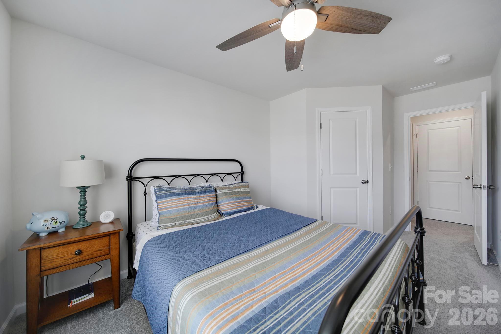 7032 Everly Commons Lane Fort Mill, SC 29708 - Photo 24 of 37 a bedroom with a bed and a chandelier