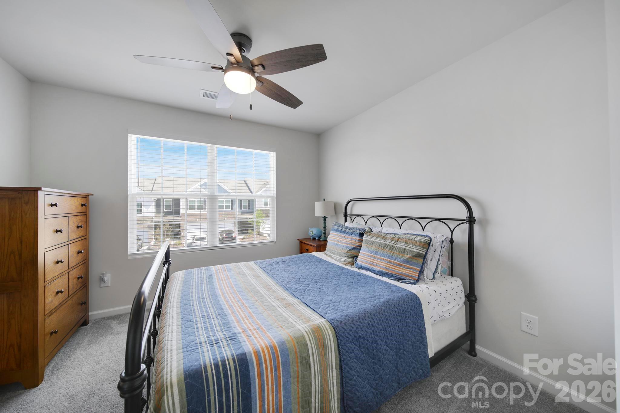 7032 Everly Commons Lane Fort Mill, SC 29708 - Photo 25 of 37 a bedroom with a large bed and a large window