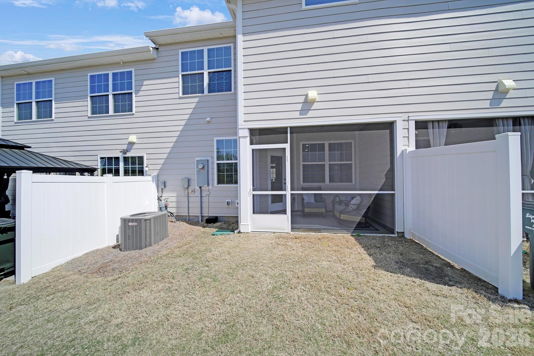 7032 Everly Commons Lane Fort Mill, SC 29708 - Photo 29 of 37 a view of a house with a large window and wooden fence