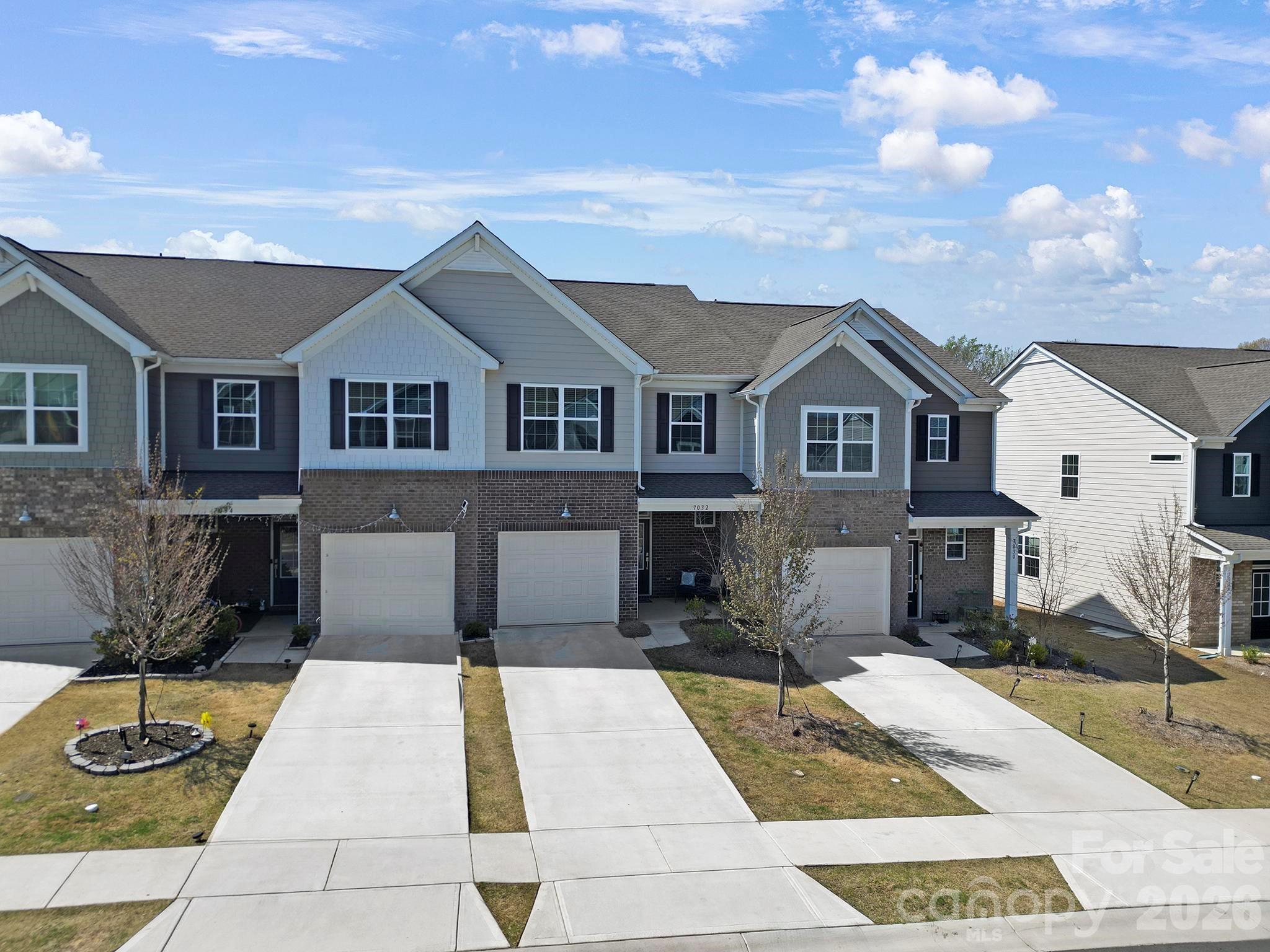7032 Everly Commons Lane Fort Mill, SC 29708 - Photo 31 of 37 a front view of a house with a garden