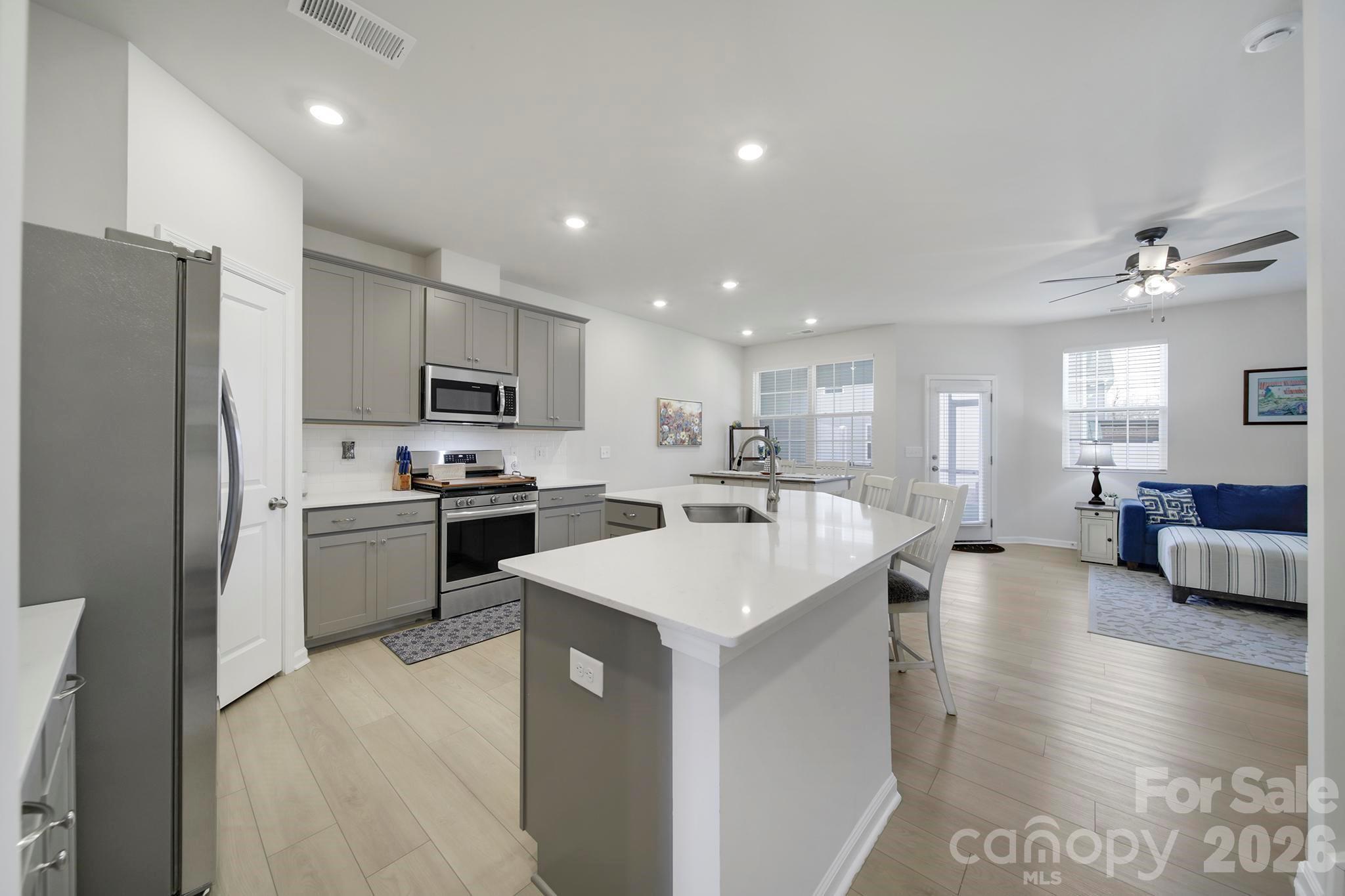 7032 Everly Commons Lane Fort Mill, SC 29708 - Photo 6 of 37 a kitchen with a sink stainless steel appliances and white cabinets
