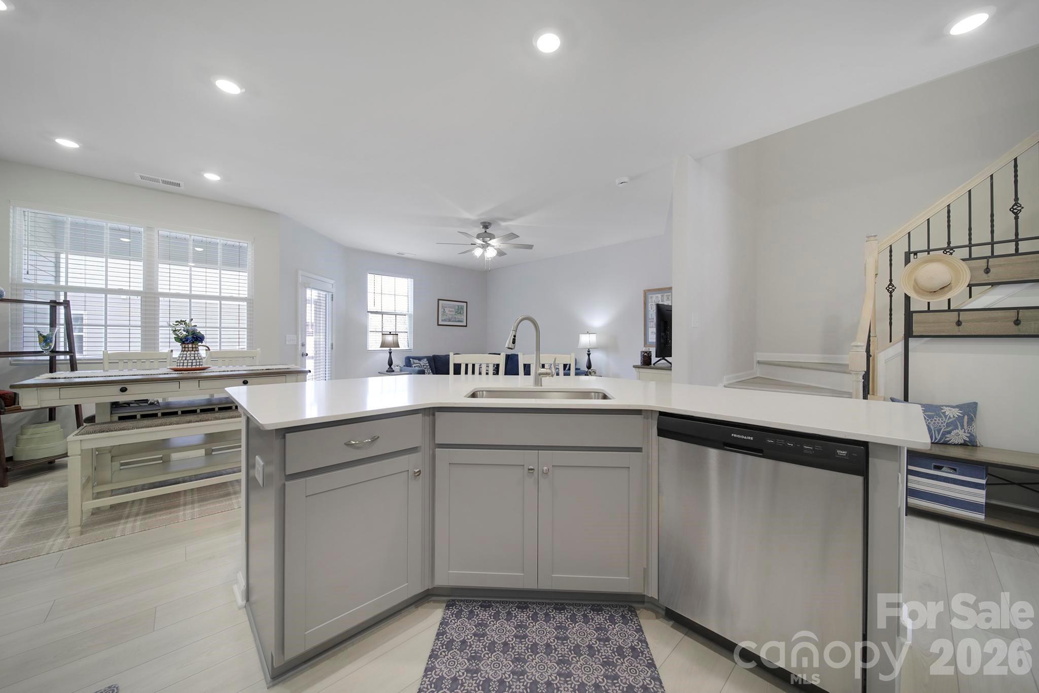 7032 Everly Commons Lane Fort Mill, SC 29708 - Photo 8 of 37 a kitchen with a sink stainless steel appliances and cabinets