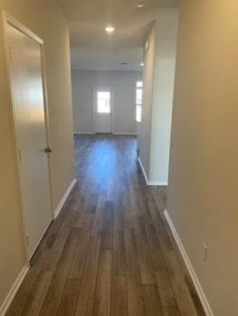 129 Onna Street Taylor, TX 76574 - Photo 12 of 12 a view of a room with wooden floor a ceiling fan and windows
