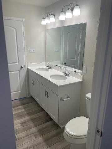 129 Onna Street Taylor, TX 76574 - Photo 3 of 12 a view of bathroom with a toilet sink and mirror