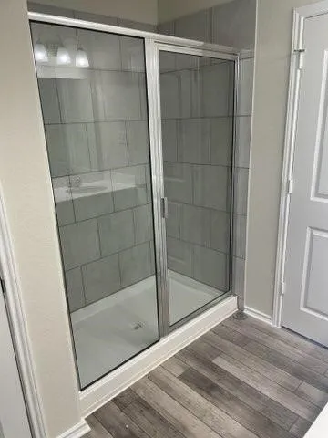 a bathroom with a glass shower door