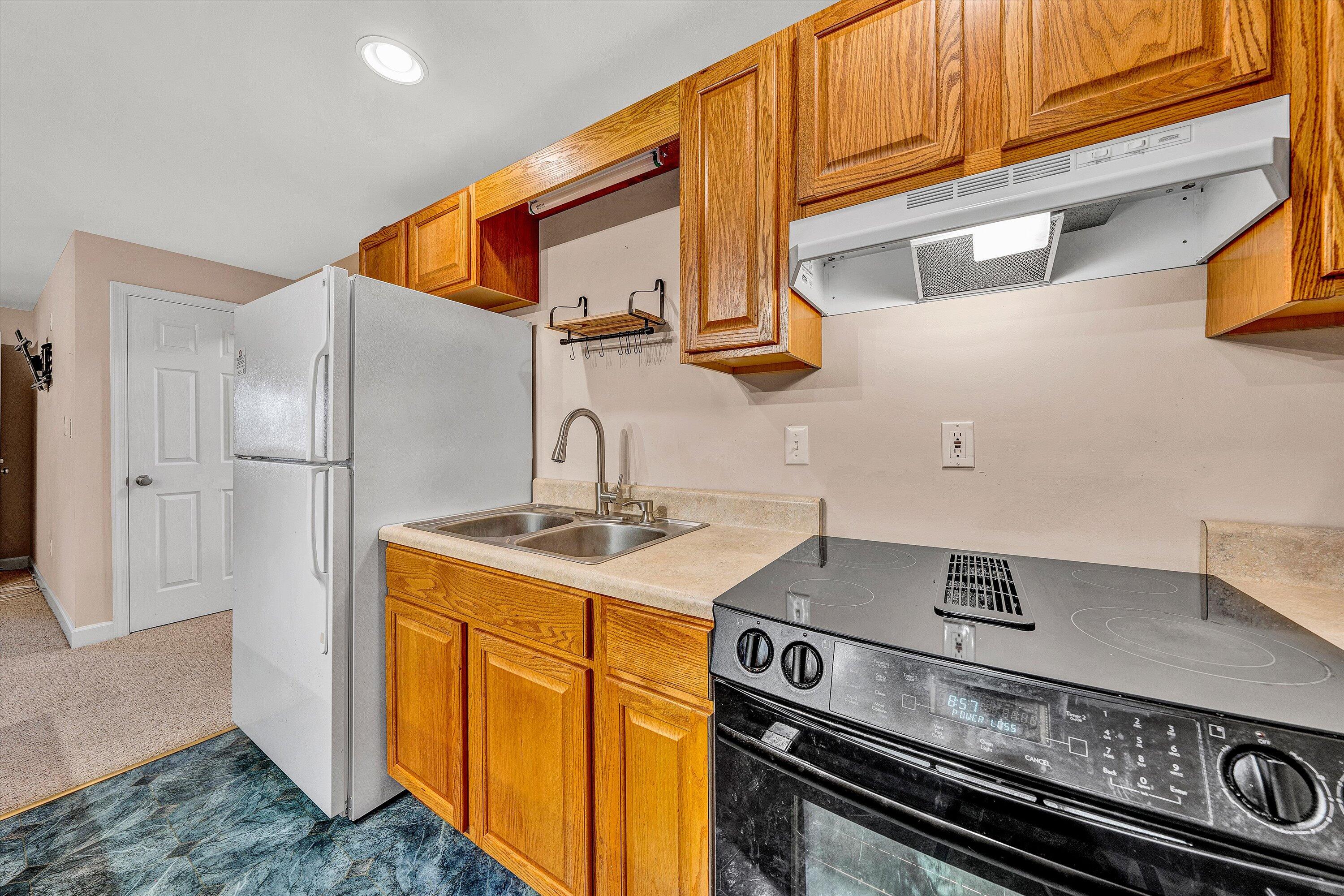 2326 Lake Retreat Road Huddleston, VA 24104 - Photo 19 of 42 a kitchen with stainless steel appliances granite countertop a stove and a refrigerator