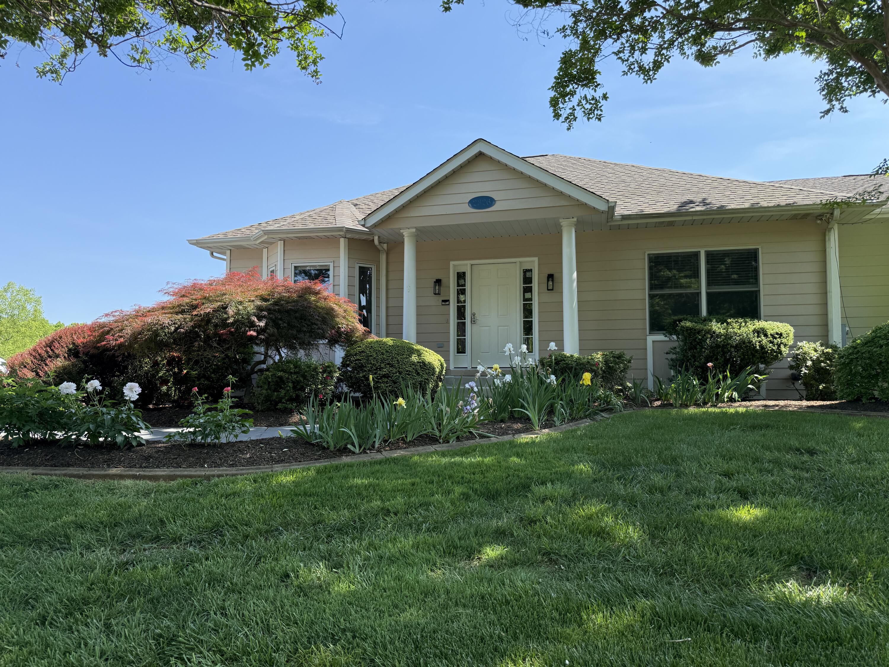 2326 Lake Retreat Road Huddleston, VA 24104 - Photo 2 of 42 a front view of a house with a garden